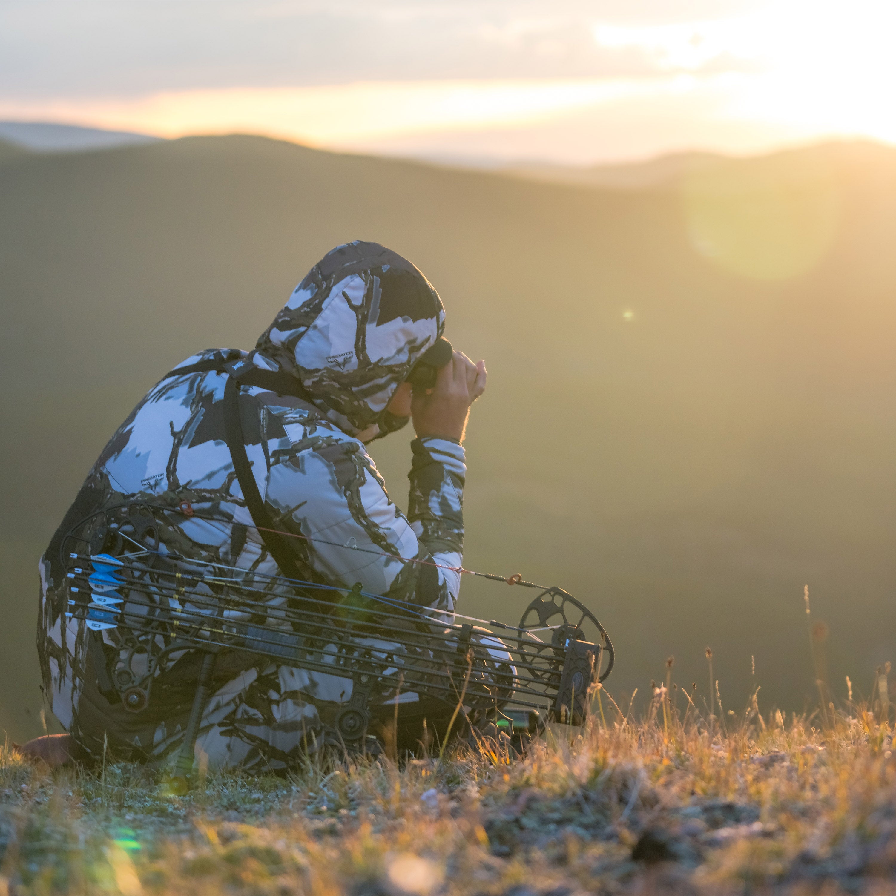 bowhunter glassing ravine in airstream jacket