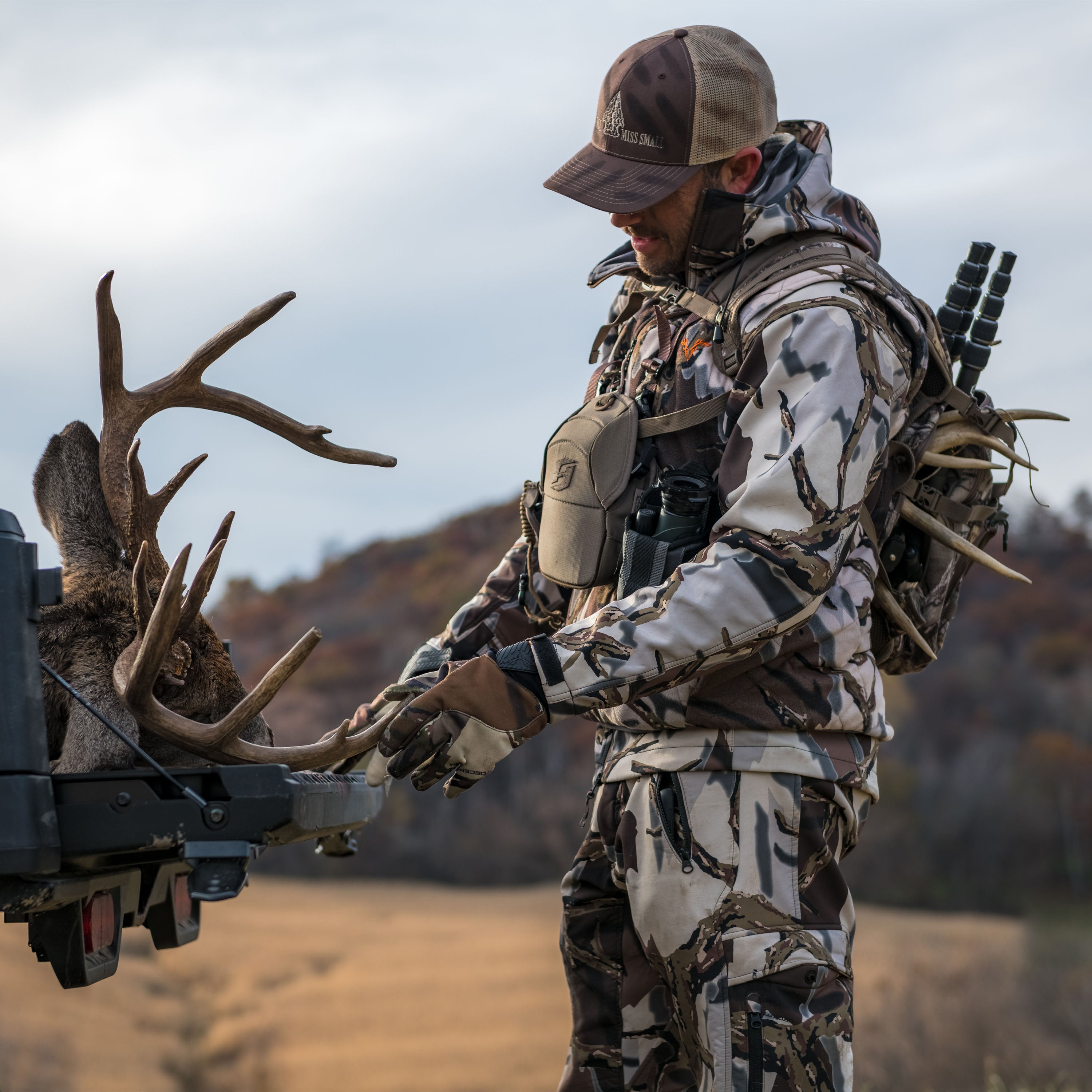 Hunter in camo with deer